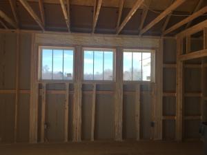 Right – The window header is filled with spray foam and sealant is used to air seal wood-to-wood seams; however, it would be preferable to design the wall to avoid so many stacked studs around the windows because they prevent the installation of wall insulation and lead to cold spots.
