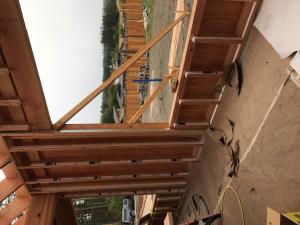 Right – The walls of this home were constructed with “insulated studs” fashioned on site by adding 2-inch-thick strips of rigid foam to the inside face of 2x4 studs then topping that with a plywood nailing surface. The rigid foam provides a thermal break for each stud and provides more room for blown in insulation. 