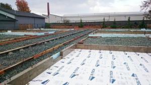 Right - The slab-on-grade foundation is insulated with two layers (R-20) of XPS foam under the-slab and R-10 on the exterior of the stem walls.
