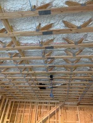 Right - The ceiling above the garage is insulated and air-sealed with open-cell spray foam to keep garage fumes out of the living space above. 