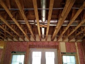 Right – Fiberglass batt insulation fills the walls while the floor joists above are insulated with spray foam insulation to both insulate and air seal this transition space.