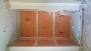 Right – The air- and water-barrier material lining the shower stall is mastic sealed to prevent leakage and rigid foam insulation is installed on the floor of the shower. 