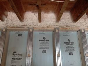 Right – The rim joists above the pre-insulated basement walls are sealed and insulated with spray foam to prevent air leakage at this juncture in the building envelope. 