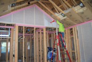 Right – A strip of foam fabric is installed along the wall top plate to serve as an air sealing gasket when the drywall is installed. 
