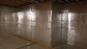 Right – The basement of this cold-climate home is insulated along interior walls with 2 inches of foil-faced rigid foam; finished basement walls also have a 2x4 interior wall insulated with R-19 blown-in fiberglass insulation and a poly vapor barrier. 