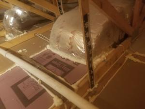 Right – Several potential sources of air leakage into the attic have been air sealed; canned spray foam was used to seal around duct boots, along seams in the drywall, and along top plates. 