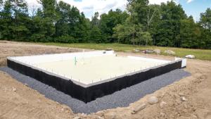 Right – The foundation of this ICF home was constructed of ICFs that were set in place on a gravel bed, then 3.5 inches (R-36) of closed-cell spray foam was sprayed directly onto the gravel, providing an effective air, vapor, and thermal barrier.