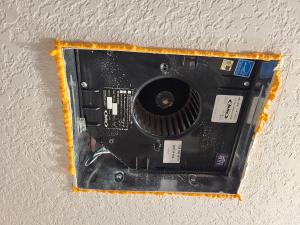 Spray foam is used to fill the small gaps around this bath fan