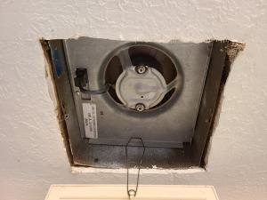 The jagged edges of the cutout around this ceiling exhaust fan require canned spray foam, metal tape, or fiberglass mesh tape and mastic to air seal the gaps and keep conditioned air from the home from escaping into the attic 