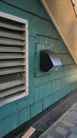 An exhaust fan is properly ducted to an exterior wall vent 