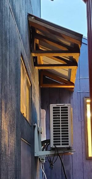 A permanent awning prevents snow and overflowing ice dams from causing damage to HVAC equipment below.