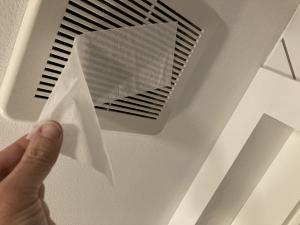 To test bathroom exhaust fan airflow, hold a tissue up to the fan while it is running; if it holds, airflow is good.