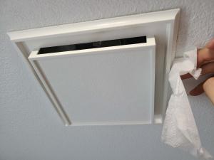 Wrong - Bathroom fan should have enough suction to hold a tissue.