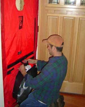 Contractors use a blower door to measure overall house air leakage.