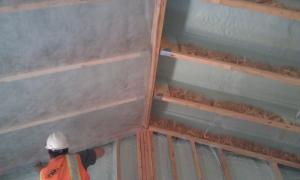 This builder applied an air-sealing layer of spray foam along the underside of the roof deck and the inside of the walls before filling the wall cavities with blown cellulose.