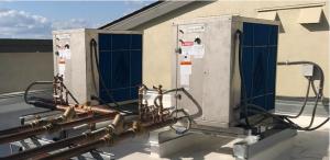 Wrong: The exhaust air from one heat pump water heater is blowing into the intake of the heat pump water heater next to it  
