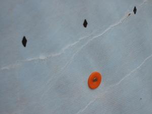 Cap nail securing a weather-resistant barrier