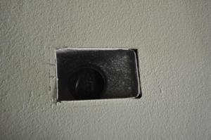 The gaps between the sheet metal of the duct boot and the drywall are clearly visible in this image.