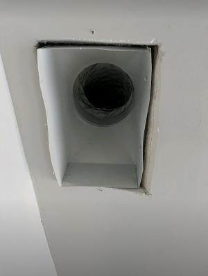 With the register grill removed, very large gaps are visible around the edges of this duct boot between the duct boot and the drywall; the gaps can be closed with screw or heavy staples then sealed with caulk, mastic, or metal tape.