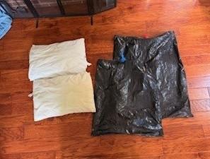 Two pillows and two garbage bags are used to make a chimney air sealing pillow