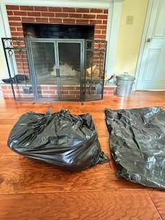 Pillows or batt insulation are placed into first one garbage bag and that is placed into a second bag before being installed in the fireplace flue to stop chimney drafts