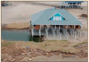 Coastal flooding washed away most of the first floor of this home; however, the piers and roof are still standing.
