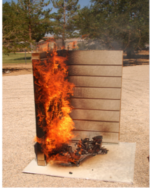 The combustible siding product on the left side in this demonstration burns readily when exposed to a burning wood sample, while the noncombustible siding on the right does not ignite