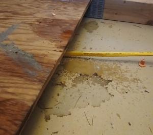 Condensation has dripped onto this board and drywall from an uninsulated condensate line on an air conditioner located just above the photo in this unconditioned attic; the water pooling on the drywall will likely soon become evident from below.