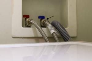 When installing a new clothes washer, connect the hot, cold, and drain hoses; the drain hose should extend less than 6 inches into the drain to allow an air gap so that water doesn’t get siphoned back into the washing machine.