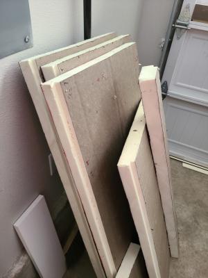 Pieces of rigid foam insulation are cut to size to be fitted into the garage door.