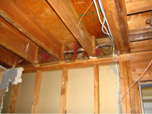 Wrong - When ceiling joists over a garage run perpendicular to the adjoining wall, the joist bays must be blocked and sealed to prevent garage fumes from entering the living space