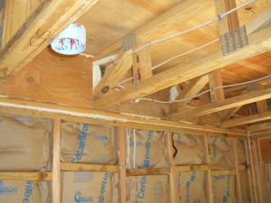 Foam holes in open-web floor trusses to completely seal the rim joist