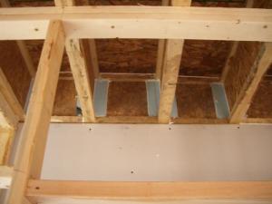 Use caulk or spray foam to air-seal all four edges of the blocking material in each joist bay.
