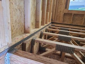 Right - A drywall gasket is installed along the top plate before installed drywall.