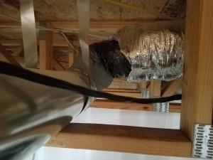 Wrong - Duct insulation and vapor barrier do not cover all of the flex duct.