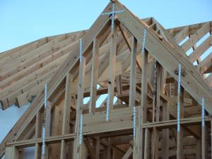 Right - The wall framing is connected to roof framing with metal ties for hurricane-resistant construction.