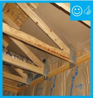 Right - Continuous wall sheathing and blocking has been installed to brace the raised heel trusses.