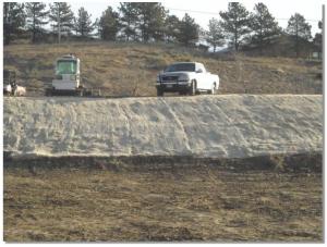 An erosion control blanket protects the slope from erosion and provides favorable conditions for bank revegetation