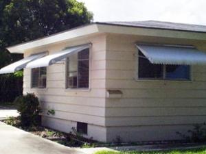 The window awnings on this house provide a simple but very effective way to reduce solar gains while still allowing view, daylight, and ventilation through the windows