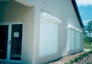The light-colored exterior roll-down shades on this building, and the shaded entryway provide very effective control of solar heat gain