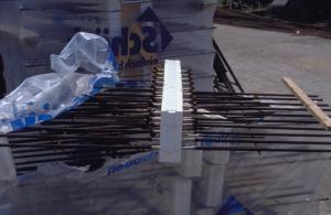These prefabricated rebar assemblies use stainless steel and rigid foam to provide a thermal break where a concrete floor slab passes through the exterior wall of a multistory building; the stainless steel is connected to carbon steel rebar 