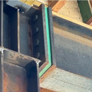 A ceramic panel provides the thermal break in the slab at the exterior wall of a multistory multifamily building; steel bolts provide structural support through the thermal break