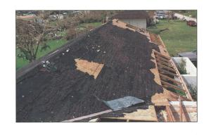 Failure of composition roof shingles and underlayment due to high winds.