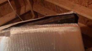 This duct board seam failure is due to the failed tape adhesive.