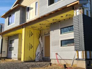 Right - Mold- and water-resistant fiber glass insulating sheathing is installed after panelized walls are assembled on site.