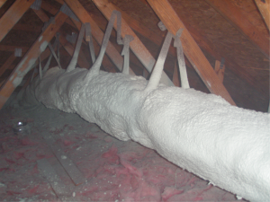 Encapsulated ducts are sprayed with ccSPF in an unconditioned attic