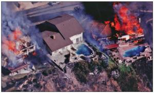 This house survived a wildfire due in part to fire-resistant walls and roof while surrounding houses were destroyed (Photo from Decra Roofing Systems, Used With Permission). 