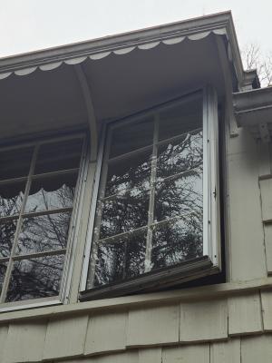 These storm windows are attached to operable casement windows, allowing for ventilation and fresh air when desired.