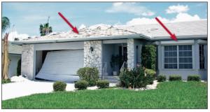 This garage door was blown from its track by positive wind pressure and adhesive-set roof tiles were pulled up but the windows were protected by roll-up shutters from the 140 to 160 mph hurricane winds. 