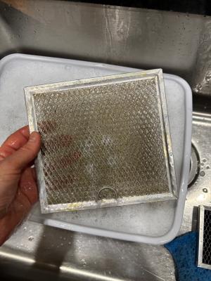 Washable range hood filters can be soaked in a pan of warm water with dish soap